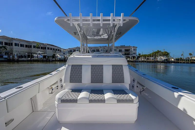  Yacht Photos Pics 2024 Invincible 39 Open Fisherman boat interior with seating, dockside view.