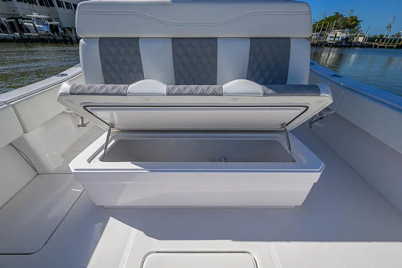  Yacht Photos Pics 2024 Invincible 39 Open Fisherman boat with open storage compartment and cushioned seating.
