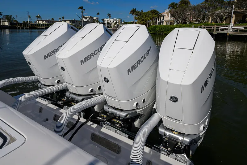  Yacht Photos Pics Four Mercury outboard engines on a 2024 Invincible 39 Open Fisherman boat, docked by the water.