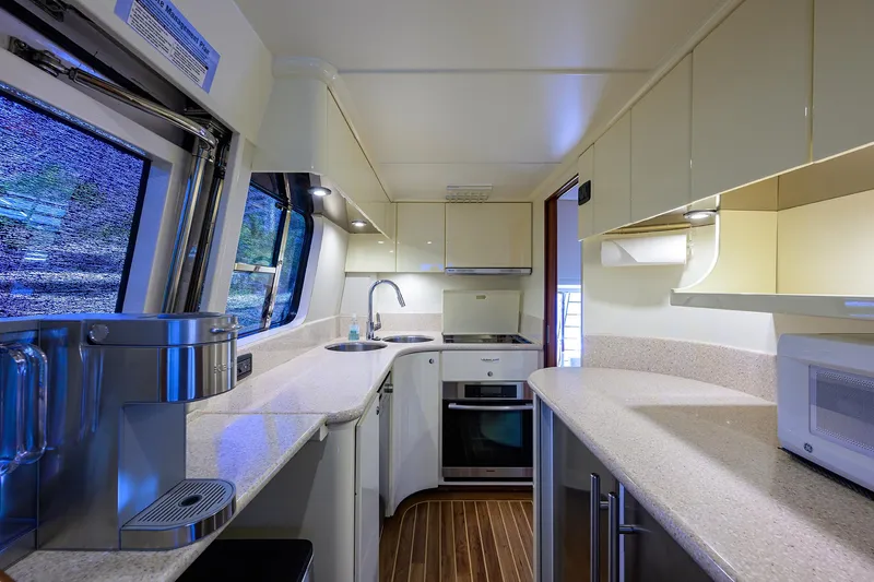 Sea Hawk Yacht Photos Pics Modern kitchen interior of a 1997 Fairline Squadron yacht with sleek countertops and appliances.