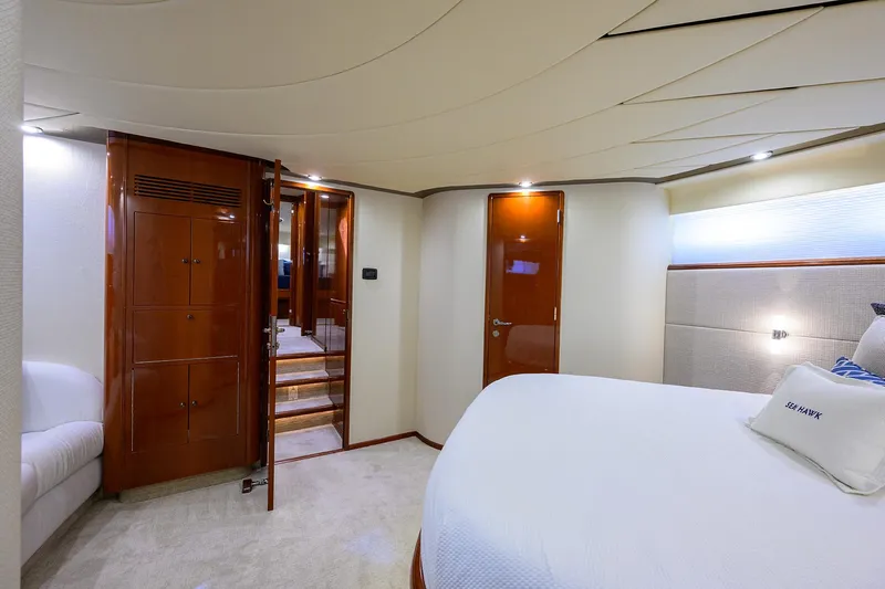 Sea Hawk Yacht Photos Pics Luxurious bedroom interior of a 1997 Fairline Squadron yacht with wooden accents.