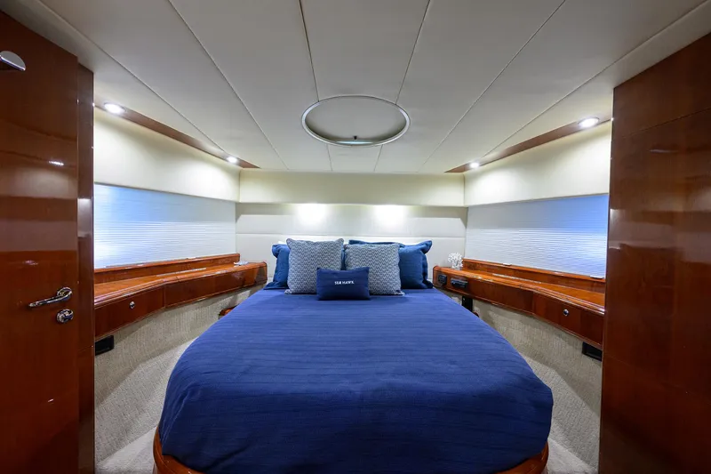 Sea Hawk Yacht Photos Pics Luxurious bedroom interior of 1997 Fairline Squadron yacht with blue bedding.