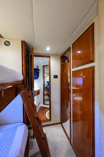 Sea Hawk Yacht Photos Pics 1997 Fairline Squadron yacht interior with wooden cabinets and bunk beds.