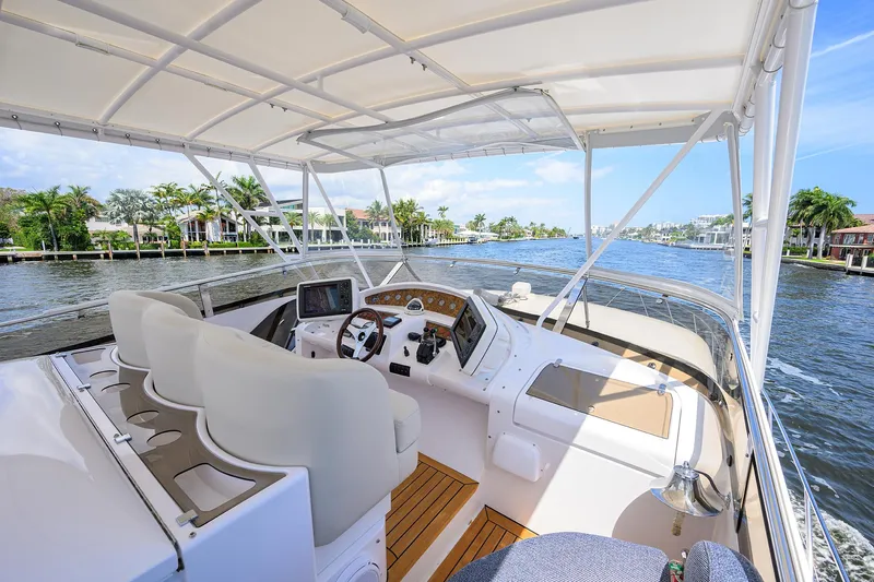 Sea Hawk Yacht Photos Pics 1997 Fairline Squadron yacht helm with waterfront view, featuring modern navigation equipment.