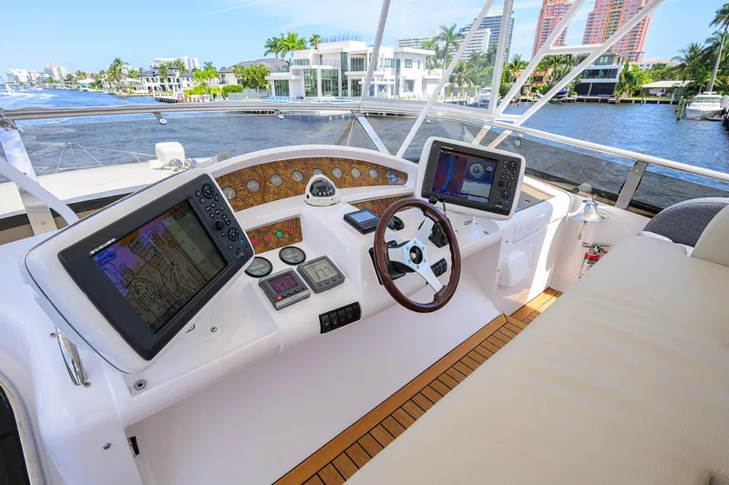 Sea Hawk Yacht Photos Pics 1997 Fairline Squadron yacht helm with navigation screens and waterfront view.