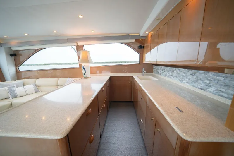  Yacht Photos Pics Luxurious interior of 2005 Viking 52 Convertible yacht with modern kitchen and seating area.