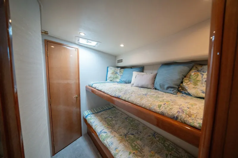  Yacht Photos Pics 2005 Viking 52 Convertible yacht cabin with bunk beds and floral bedding.