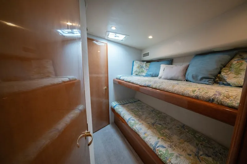  Yacht Photos Pics Interior of 2005 Viking 52 Convertible yacht with cozy bunk beds and wooden finishes.