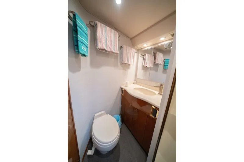  Yacht Photos Pics Bathroom interior of 2005 Viking 52 Convertible yacht with towels and modern fixtures.