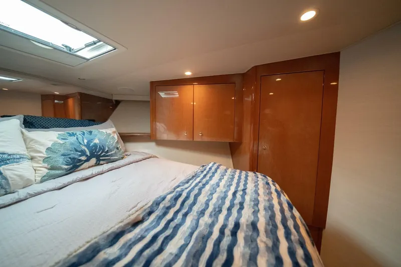 Yacht Photos Pics Luxurious cabin interior of 2005 Viking 52 Convertible yacht with elegant wood cabinetry.
