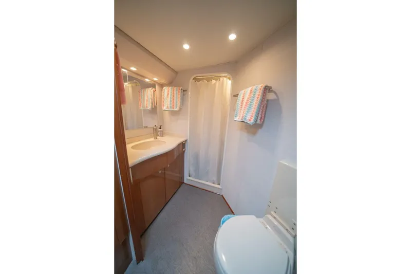  Yacht Photos Pics Bathroom interior of 2005 Viking 52 Convertible yacht with shower and sink.