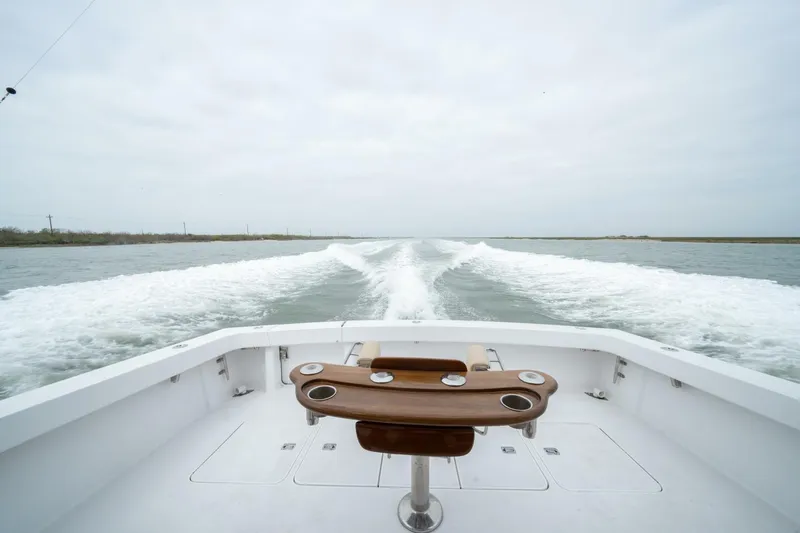  Yacht Photos Pics 2005 Viking 52 Convertible boat cruising, view from deck with wake in water.