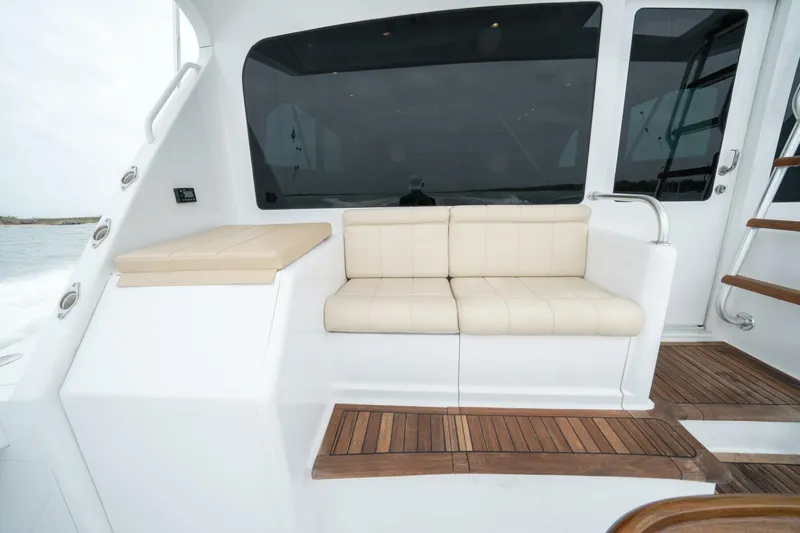  Yacht Photos Pics 2005 Viking 52 Convertible yacht with beige seating and wooden deck.