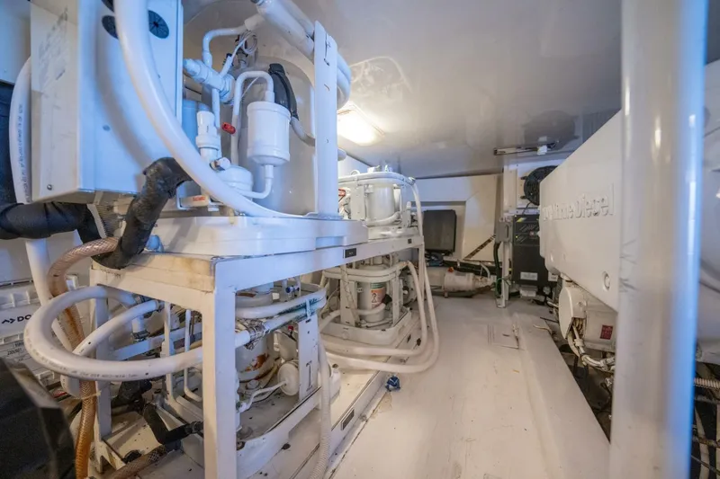  Yacht Photos Pics Engine room of a 2005 Viking 52 Convertible yacht, showcasing complex machinery and piping.
