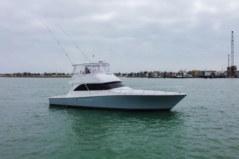  Yacht Photos Pics 2005 Viking 52 Convertible yacht on calm waters under cloudy skies.