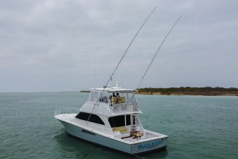  Yacht Photos Pics 2005 Viking 52 Convertible yacht on calm waters under cloudy skies.