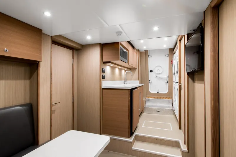 Crescent Lady Yacht Photos Pics Luxurious 2019 Crescent Semi-Displacement yacht interior with modern kitchen and sleek wood finishes.