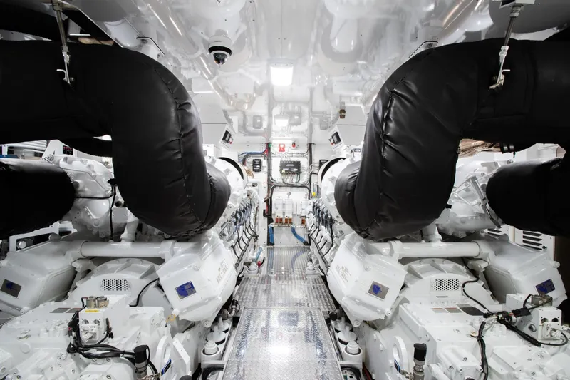 Crescent Lady Yacht Photos Pics Engine room of 2019 Crescent Semi-Displacement yacht with advanced machinery and black exhaust pipes.