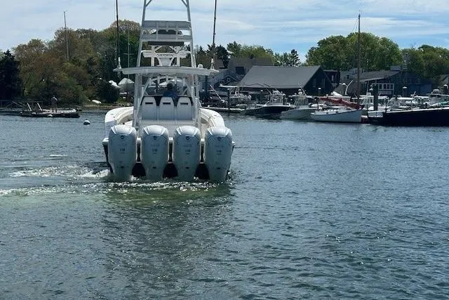  Yacht Photos Pics 2022 Regulator 41 boat with four engines cruising in a marina.