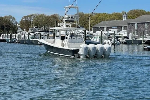  Yacht Photos Pics 2022 Regulator 41 boat with four engines docked in a marina.