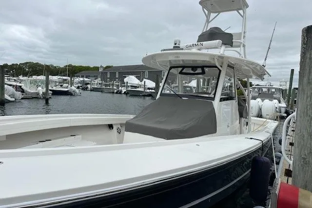  Yacht Photos Pics 2022 Regulator 41 boat docked in marina, featuring Garmin equipment and sleek design.