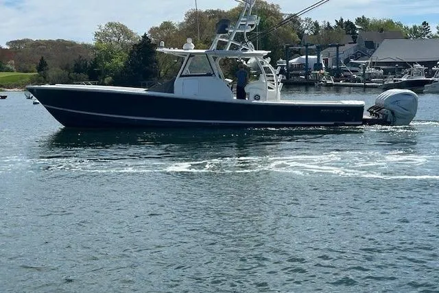  Yacht Photos Pics 2022 Regulator 41 boat cruising on a calm waterway with scenic background.