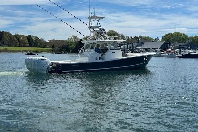  Yacht Photos Pics 2022 Regulator 41 boat cruising on a calm lake with scenic background.
