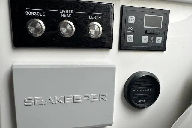  Yacht Photos Pics Control panel of a 2022 Regulator 41 boat featuring Seakeeper and water alarm.