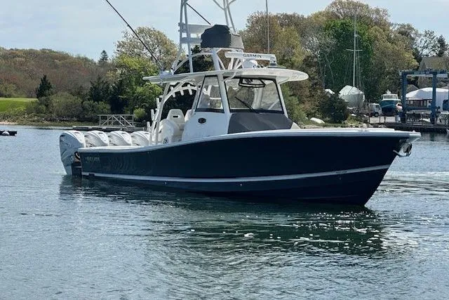  Yacht Photos Pics 2022 Regulator 41 boat on calm water, featuring sleek design and multiple engines.