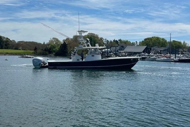  Yacht Photos Pics 2022 Regulator 41 boat cruising on a calm lake under a clear blue sky.