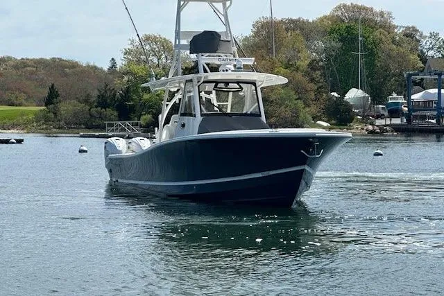  Yacht Photos Pics 2022 Regulator 41 boat cruising on a calm lake with trees in the background.