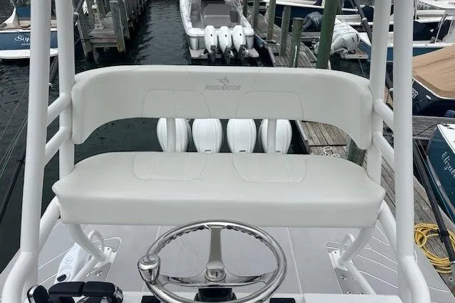  Yacht Photos Pics 2022 Regulator 41 boat helm with white seating and steering wheel at marina.