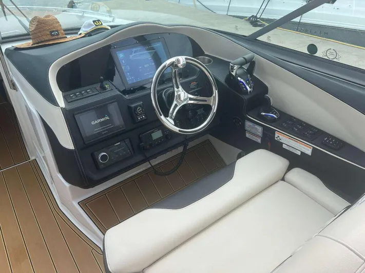  Yacht Photos Pics 2025 Regal 33 OBX boat cockpit with Garmin navigation system and modern steering wheel.