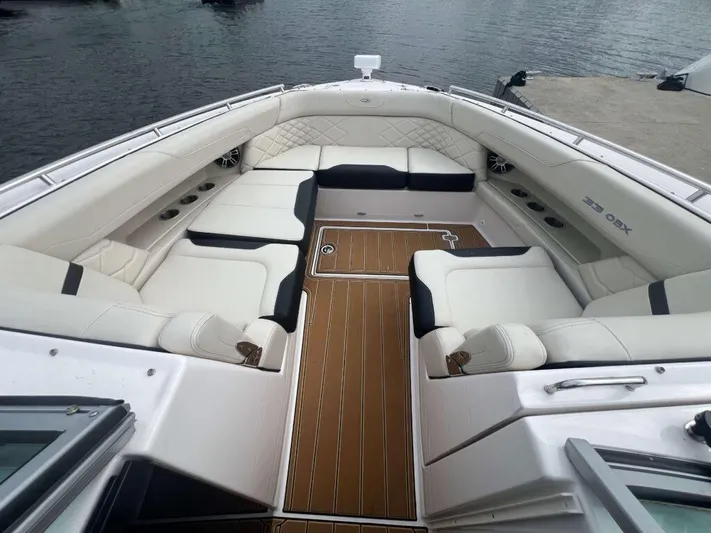  Yacht Photos Pics 2025 Regal 33 OBX boat interior with luxurious seating and wood-style flooring.