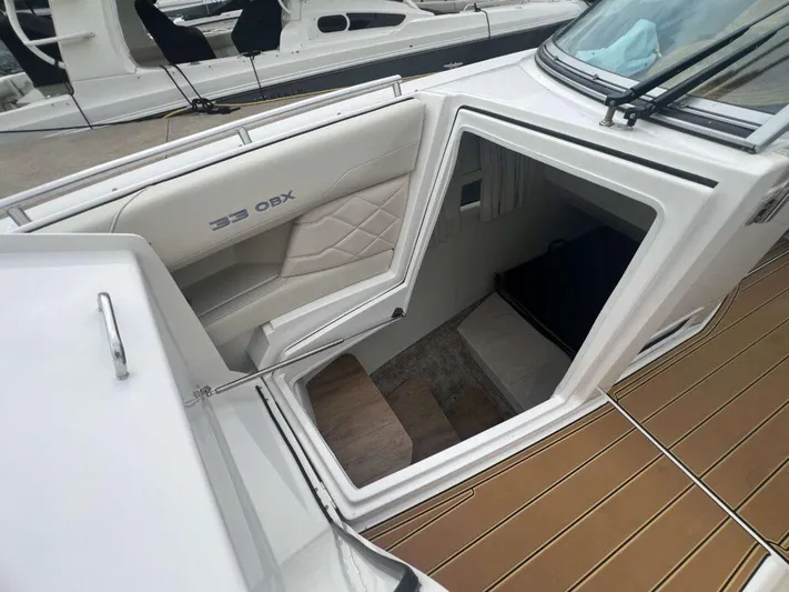  Yacht Photos Pics 2025 Regal 33 OBX boat interior with open cabin entrance and seating.