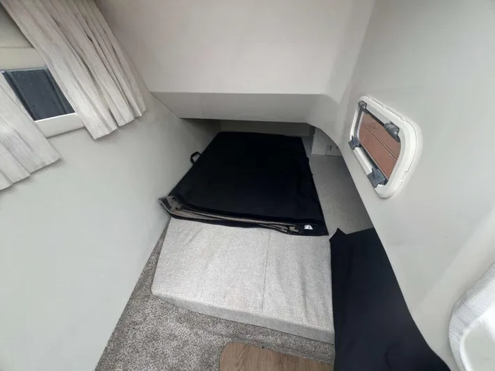  Yacht Photos Pics Interior cabin of 2025 Regal 33 OBX boat with cushions and window.