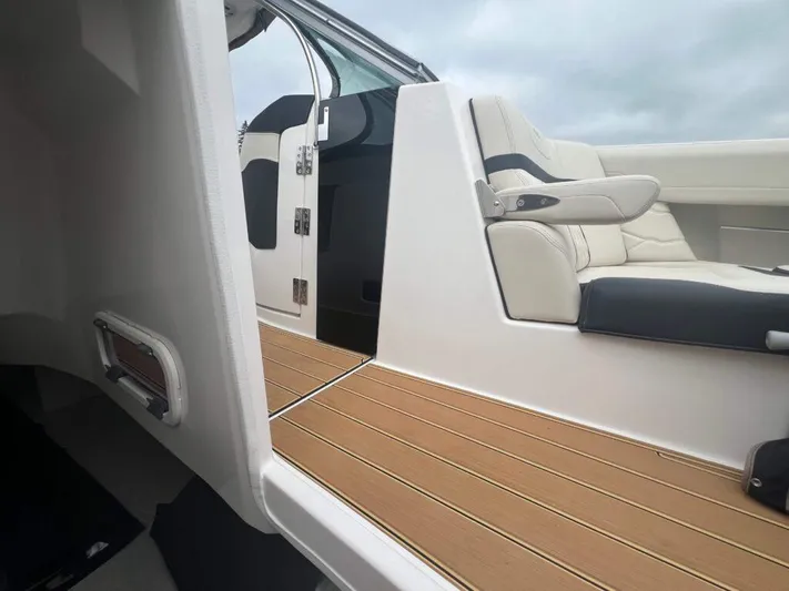  Yacht Photos Pics 2025 Regal 33 OBX boat interior with sleek seating and wooden flooring.