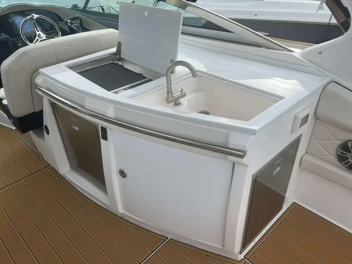  Yacht Photos Pics 2025 Regal 33 OBX boat interior with sink and storage area.