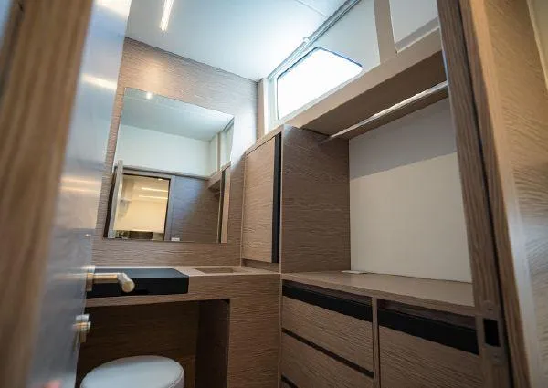  Yacht Photos Pics Modern bathroom interior on 2023 Greenline 45 Fly yacht, featuring wood cabinetry and sleek design.