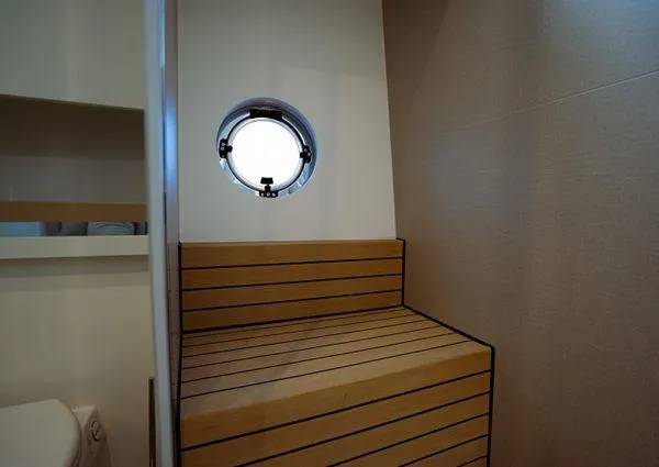 Yacht Photos Pics 2023 Greenline 45 Fly yacht interior with wooden bench and porthole window.