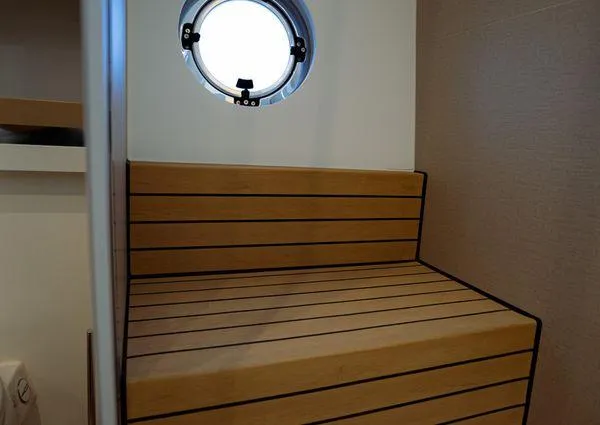  Yacht Photos Pics Interior of 2023 Greenline 45 Fly yacht with wooden bench and round window.