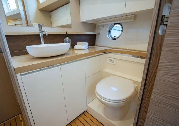  Yacht Photos Pics Modern bathroom in 2023 Greenline 45 Fly yacht with sleek fixtures and porthole window.