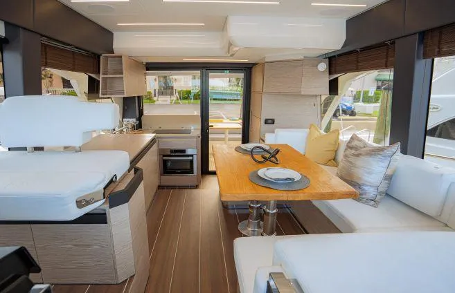  Yacht Photos Pics Luxurious interior of 2023 Greenline 45 Fly yacht with modern dining and seating area.