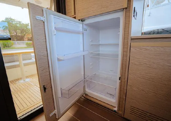  Yacht Photos Pics Open refrigerator inside 2023 Greenline 45 Fly yacht, showcasing spacious interior and modern design.
