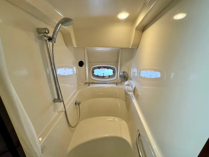 Isabela Yacht Photos Pics Luxurious bathroom in 2008 Sea Ray 48 Sundancer yacht with shower and porthole window.