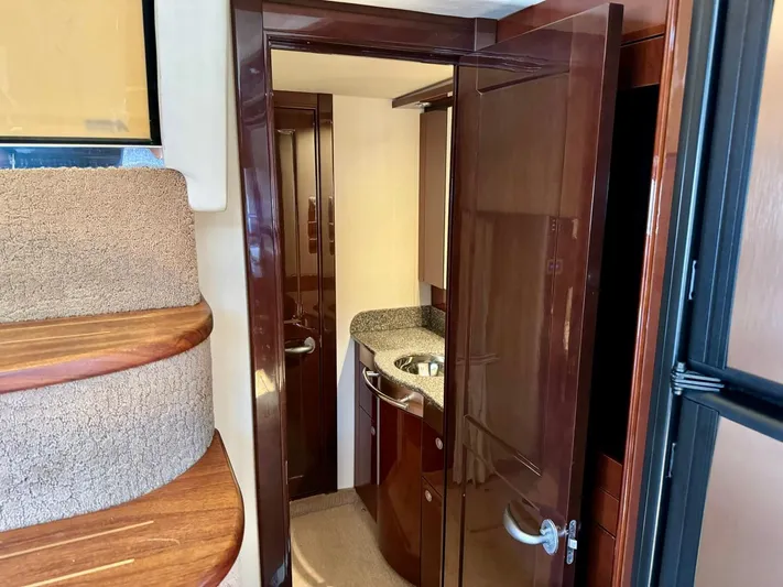Isabela Yacht Photos Pics Interior view of 2008 Sea Ray 48 Sundancer yacht, featuring a compact bathroom with wooden finishes.