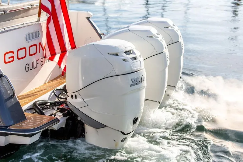 Goombay Yacht Photos Pics 2018 MJM 43z boat with triple 350 horsepower engines, American flag, on water.