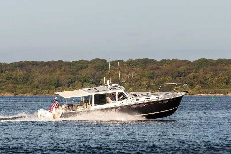 Goombay Yacht Photos Pics 2018 MJM 43z cruising on a scenic lake with lush green shoreline.