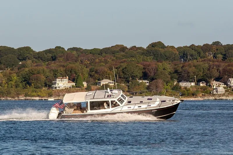 Goombay Yacht Photos Pics 2018 MJM 43z yacht cruising on a scenic lake with lush green shoreline.