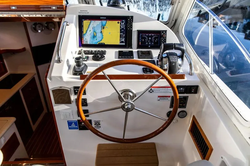 Goombay Yacht Photos Pics Cockpit of 2018 MJM 43z boat with navigation screens and wooden steering wheel.